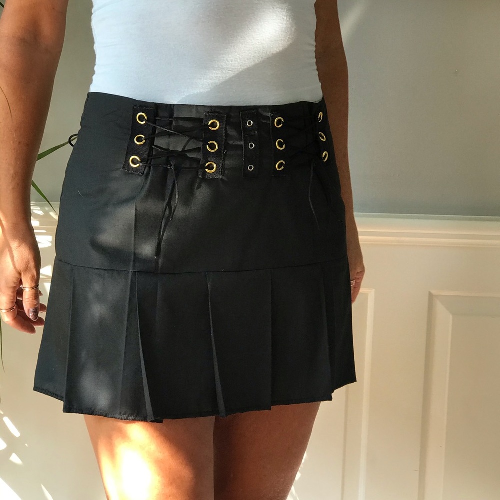 Pleated skirt with grommet lace up accents